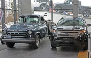 Ford car and a retro Chevrolet pickup at a car dealership