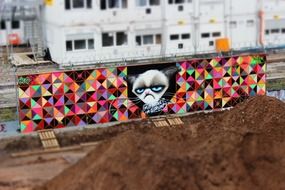 colorful graffiti on the wall with a cat face