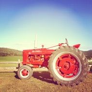 red farm tractor as a antiques