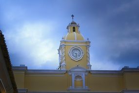 clock on the yellow building