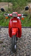 red moped on stones