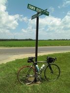 bicycle at pole with direction signs