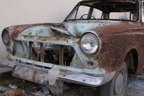 rusty car in landfill