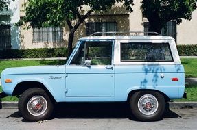 vintage blue jeep on city street