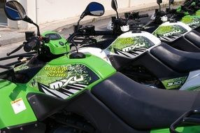 green motorcycles with leather seats close up