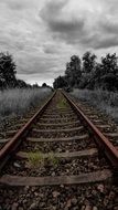 cloudy sky over railroad rails