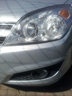 front headlight on a gray car close up