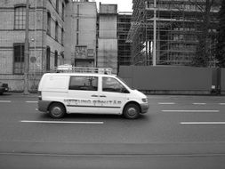 white car on a zurich road, black and white