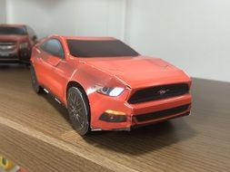 model of red car, paper toy