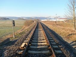 railway tracks among the green field