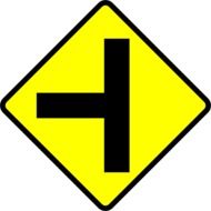 yellow sign on a bright intersection