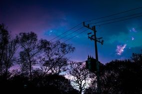 power lines on a background of blue-violet sunset