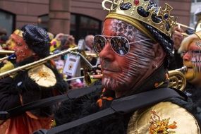 man in costume with musical instrument at carnival
