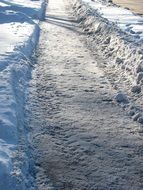 snow covered road in light and shadow