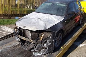 burned car on tow truck