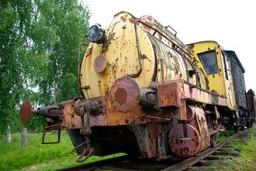 old rusty locomotive on railway at summer