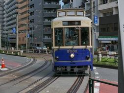 blue old tram on city street