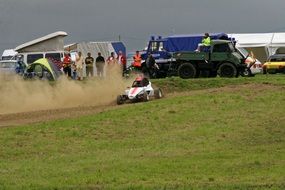 race car on the road in dust