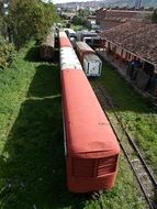 train with a red wagon on a railway