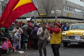 man with a flag in his hands at the festival