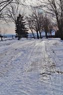 snowy road in winter at sunset