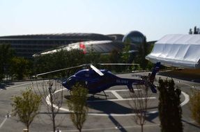 blue helicopter on helipad