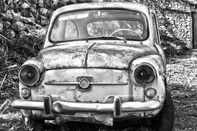 Black and white photo of the abandoned car