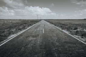 black-white highway under a cloudy sky