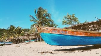 blue boat on a tropical beach