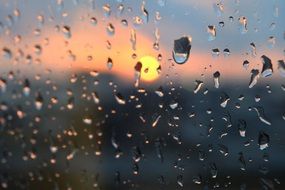 rain drops on window sunset