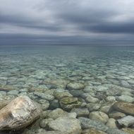 shore with clear water and stones at the bottom