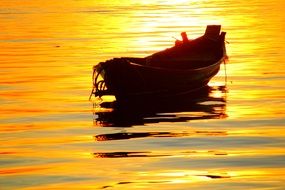 Boat in the ocean at sunset