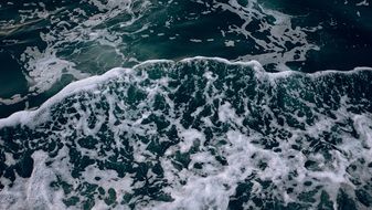 green foamy ocean waves