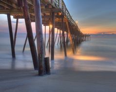 fog at a wooden pier in the ocean