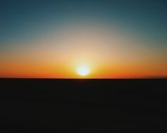glow of orange sunset in the dark