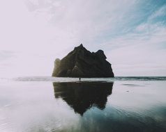 reflection of the rock on the beach