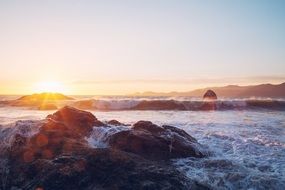 cliffs near the shore in the waves of the ocean