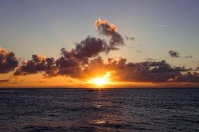 golden sun through the clouds over the ocean