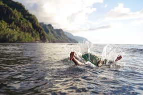 swimmer in the spray of water in the ocean