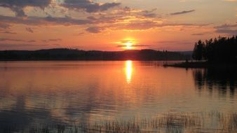 orange sunset over a lake in finland