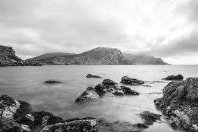 Mysterious Fog coast shore rocks stones wild black and wite