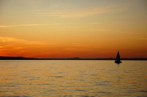 sailboat on lake constance at dusk