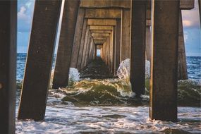 ocean waves under the pier