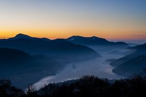 mountain river at foggy sunset