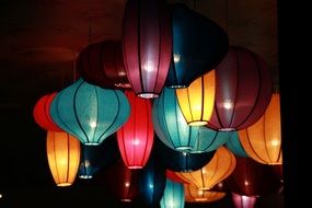 colorful decorative lanterns on dark celling