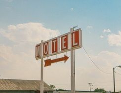 red motel sign against the sky