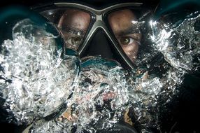 diver in a mask among the bubbles