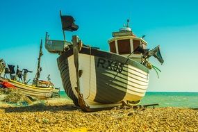 motor fishing boats on beach at water