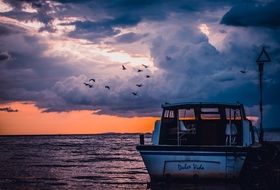 boat in the ocean at dusk