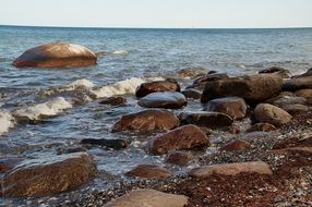 boulders in sea at surf line